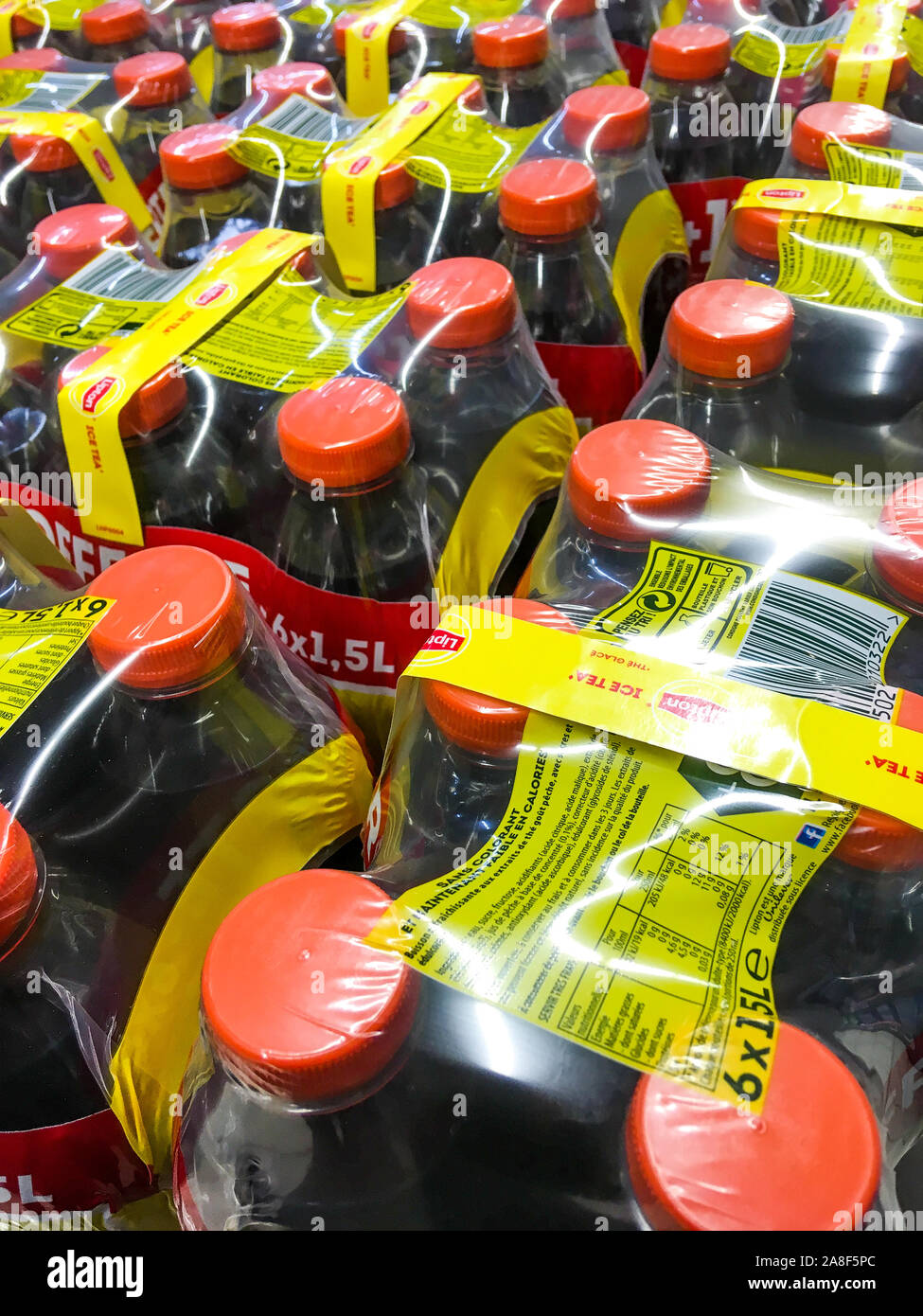 Sodas both conditioned in plastic bottles and packed under plastic film