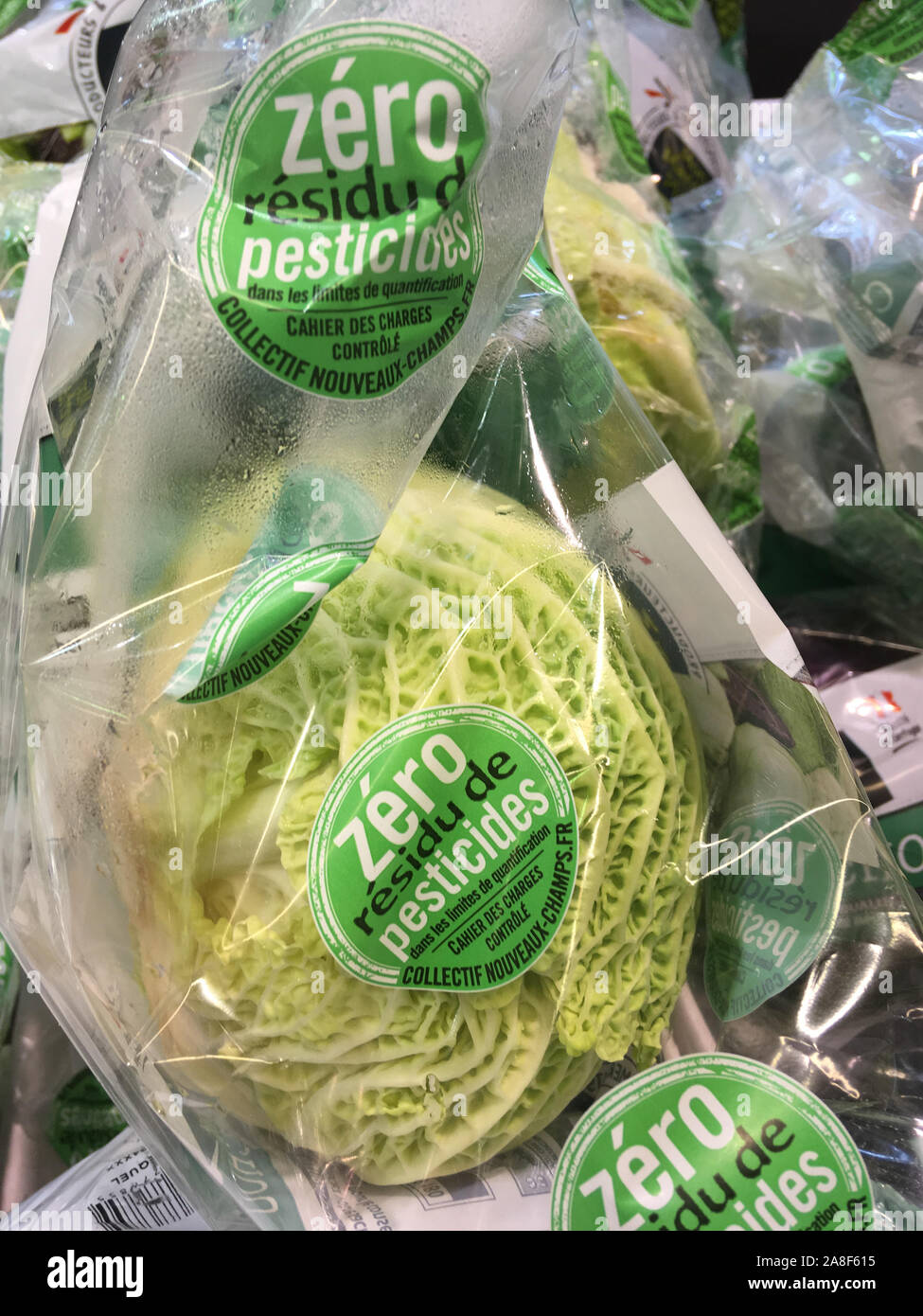 Organic cabbages under plastic package, Lyon, France Stock Photo