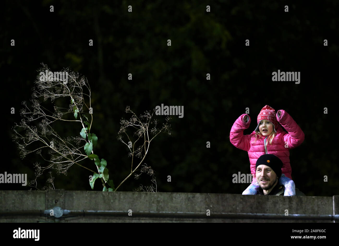 Fans watch from over a fence before the FA Cup First Round match at Champion Hill, London. Stock Photo