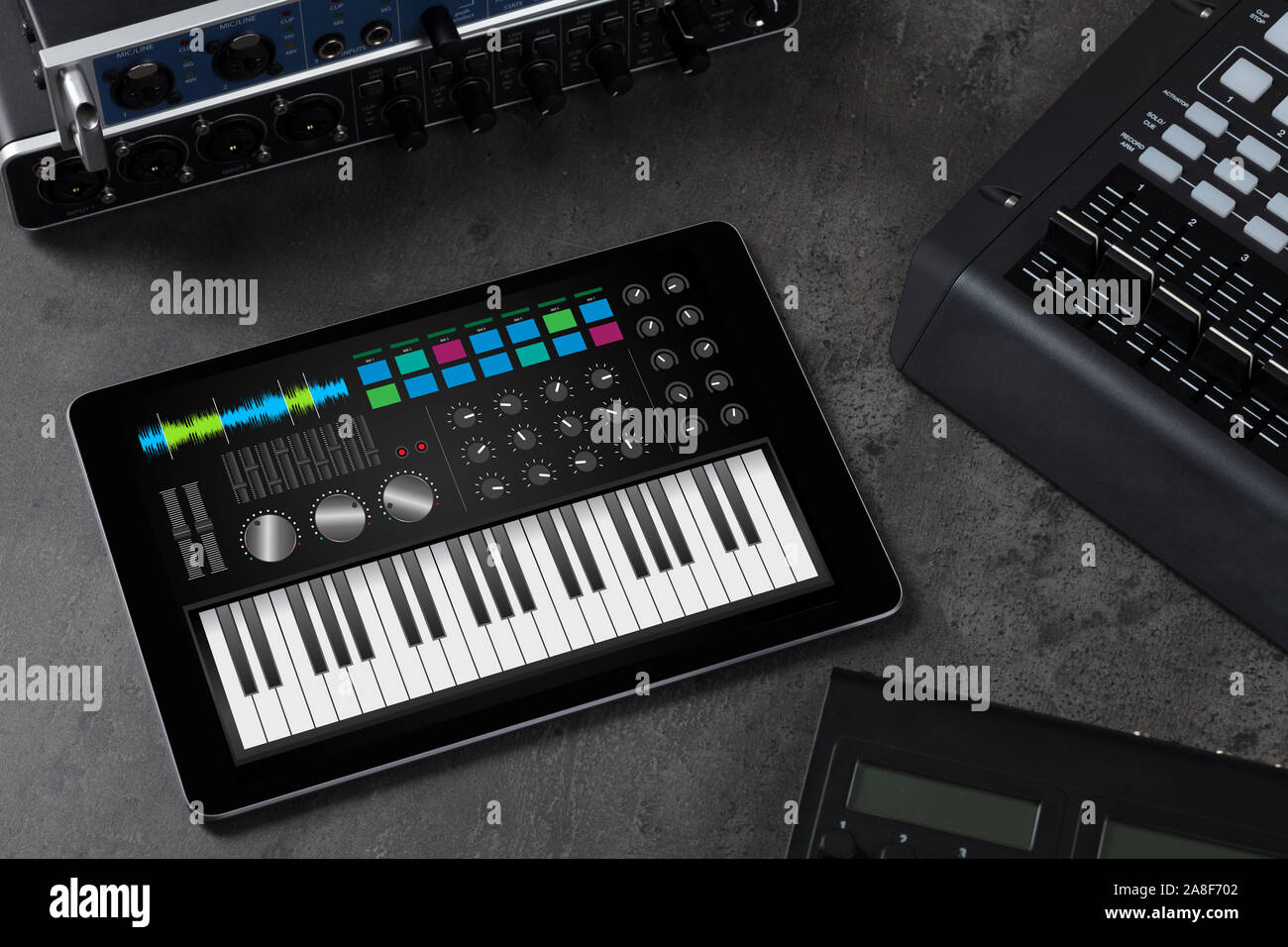 Piano synthesizer app on tablet and musical instrument concept Stock