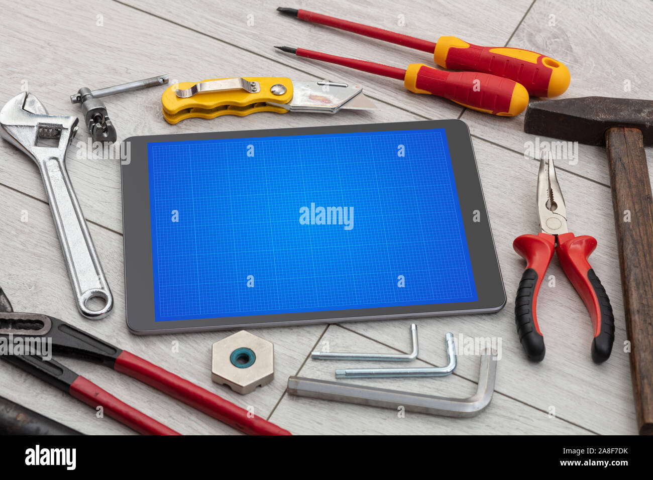 Household tools and tablet with grid screen concept Stock Photo