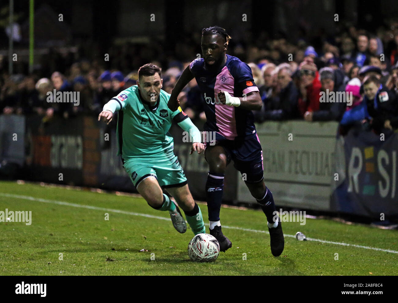Dulwich Hamlet's Jeffrey Monakana (right) in action during the FA Cup First Round match at Champion Hill, London. Stock Photo