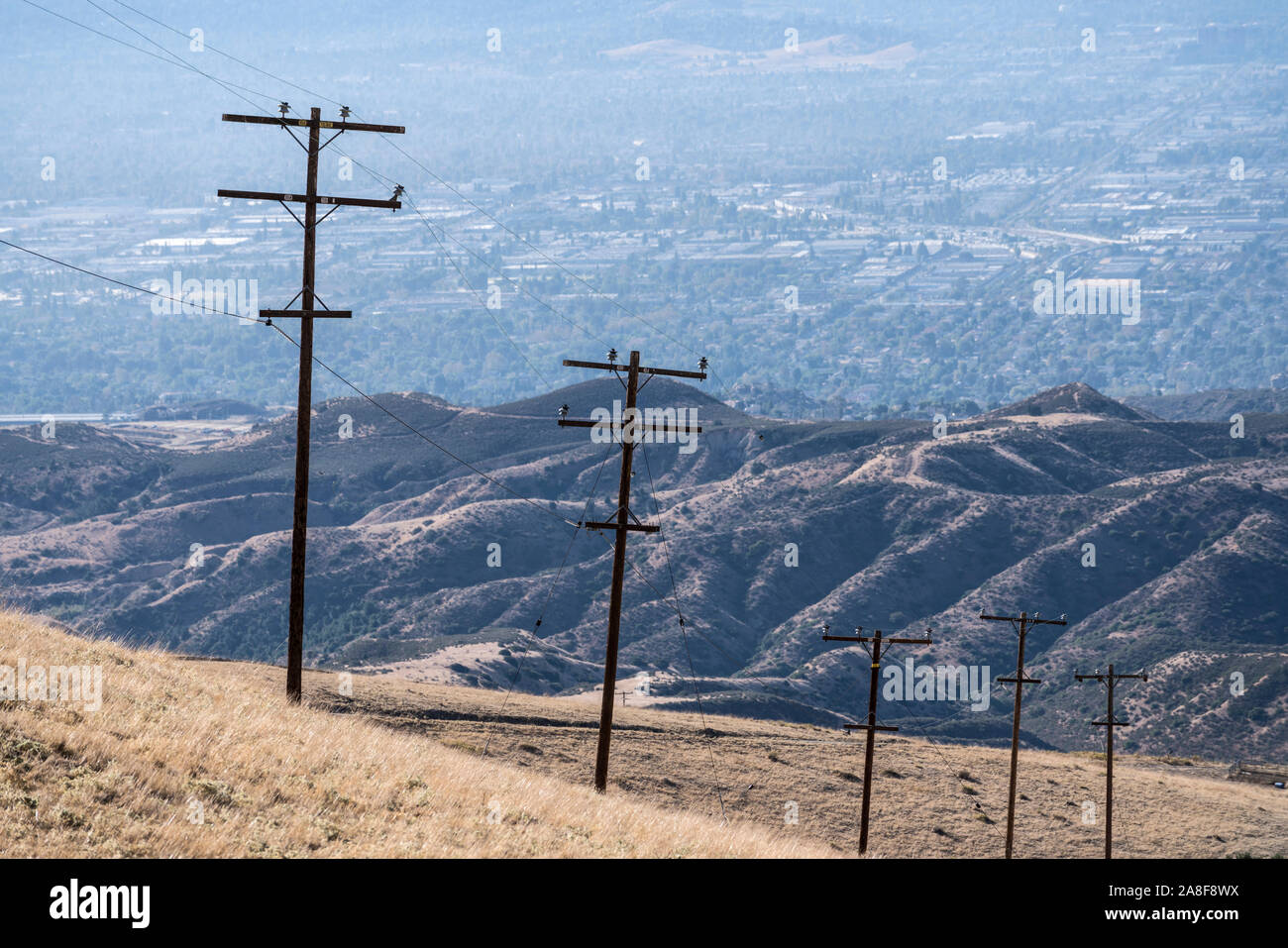 Rural power lines above dry grass hillside near Los Angeles and Ventura