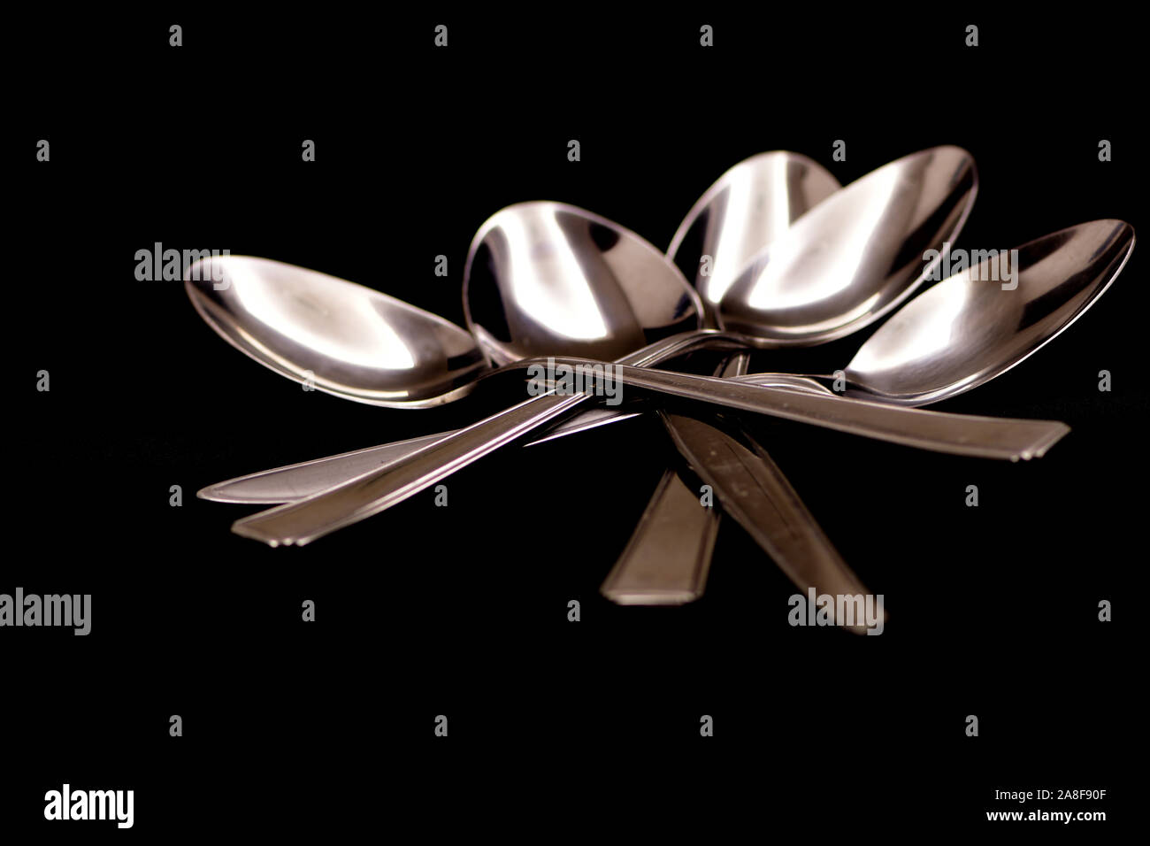 Spoons on black back ground Stock Photo