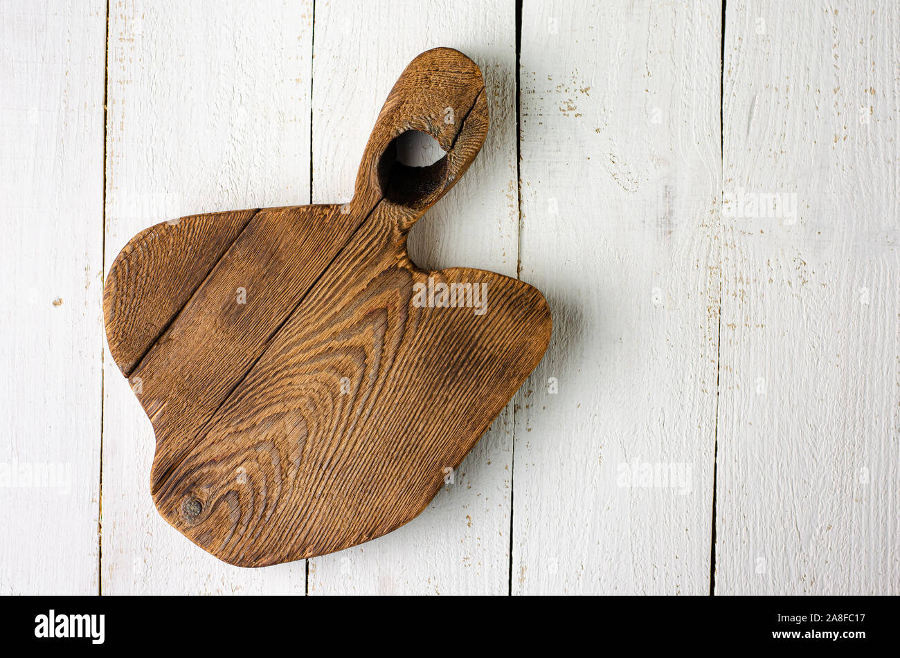 Empty wooden rustic cutting board on white background. Overhead, copy space Stock Photo