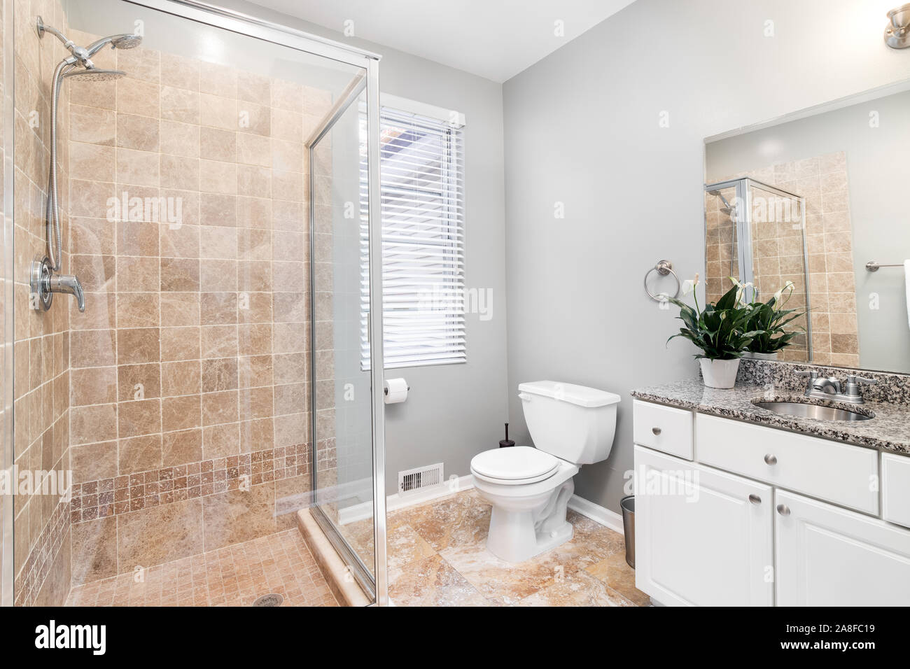https://c8.alamy.com/comp/2A8FC19/a-small-luxurious-bathroom-with-a-stand-up-shower-and-brown-marble-tiles-lining-the-floor-and-shower-a-plant-is-put-on-the-dark-marble-2A8FC19.jpg