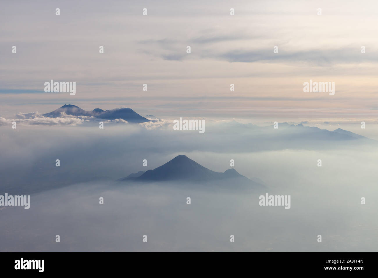 Aerial view of different volcanoes on Java Island. The fog adds to a mystical appearance of these sleeping beauties. Stock Photo
