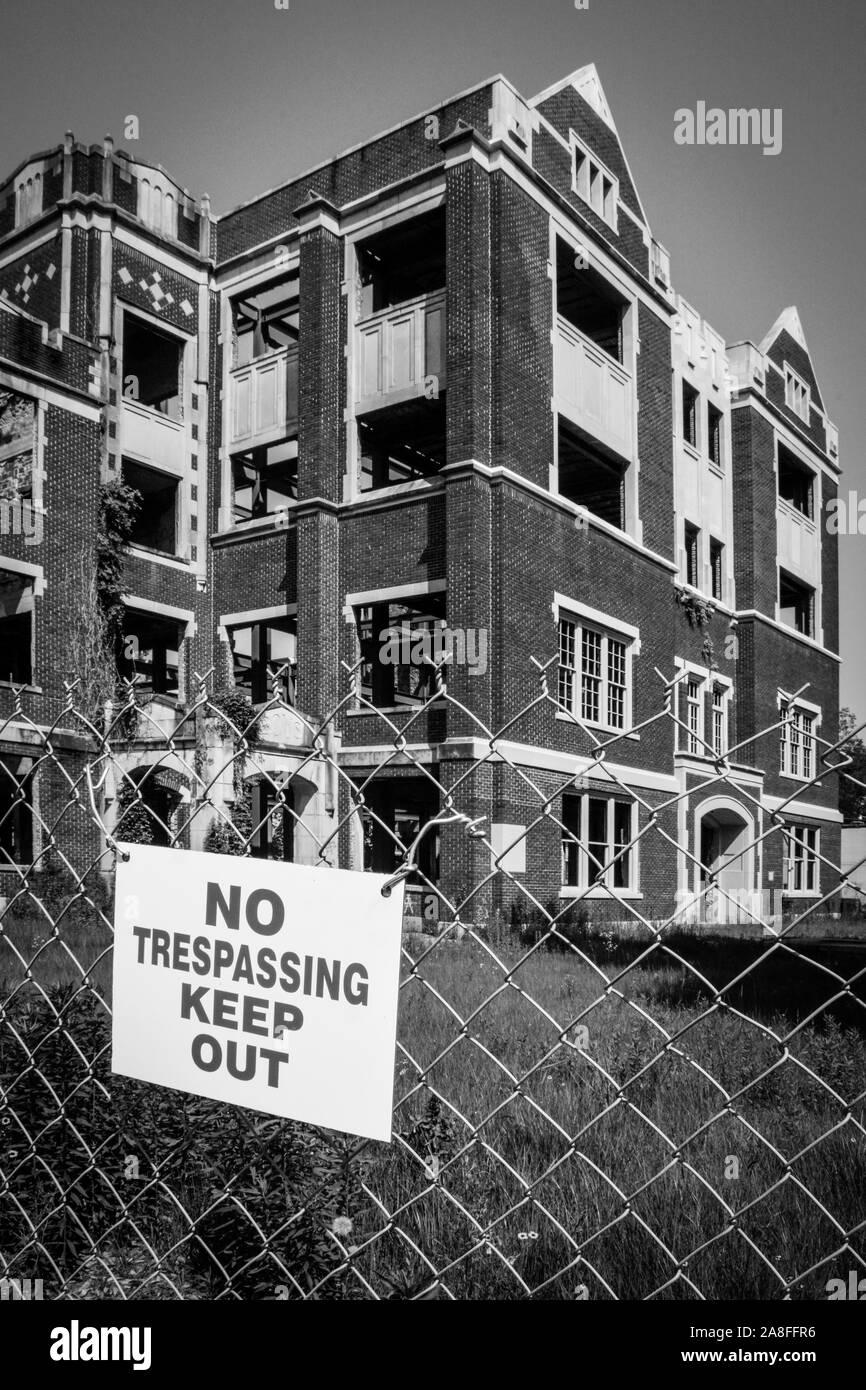 The old landmark of Hattiesburg, MS High School building, badly damaged by arsonists, fenced with Keep Out signs will be restored to senior apartments Stock Photo