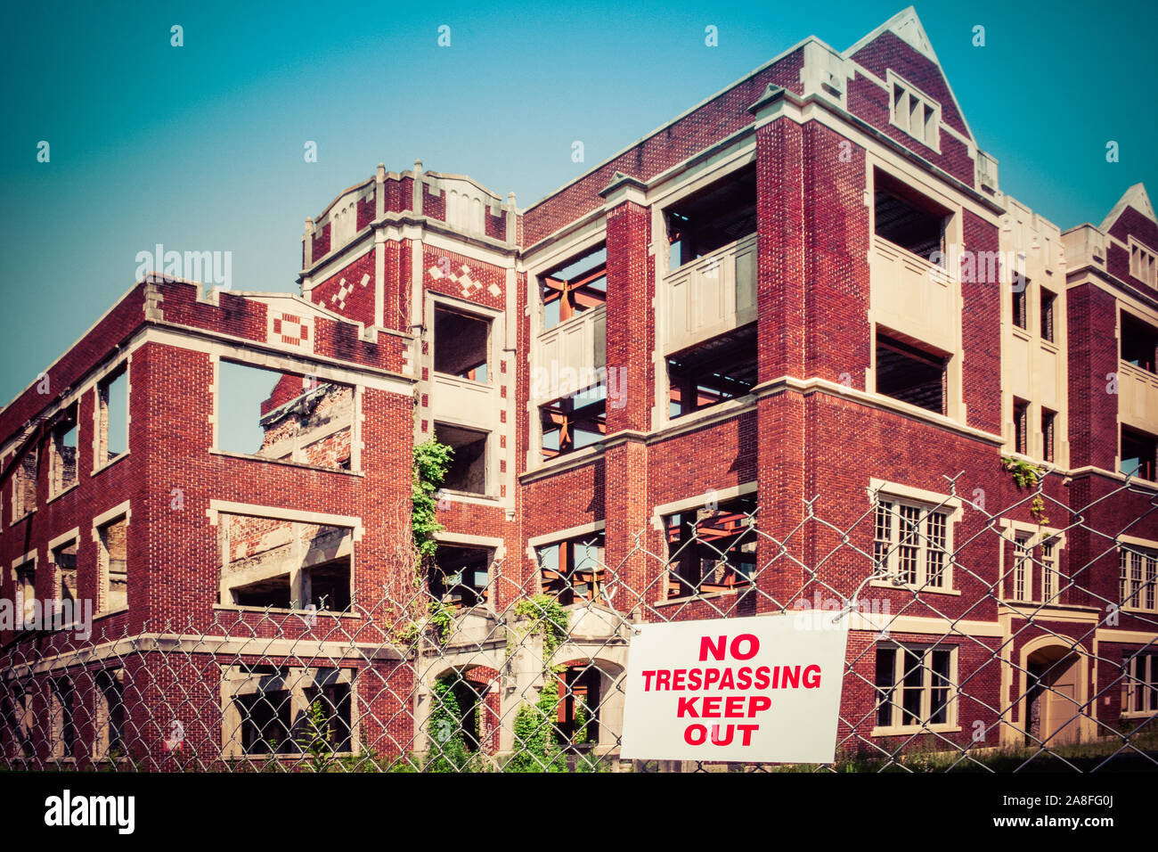 The old landmark of Hattiesburg, MS High School building, badly damaged by arsonists, fenced with Keep Out signs with be restored to senior apartments Stock Photo