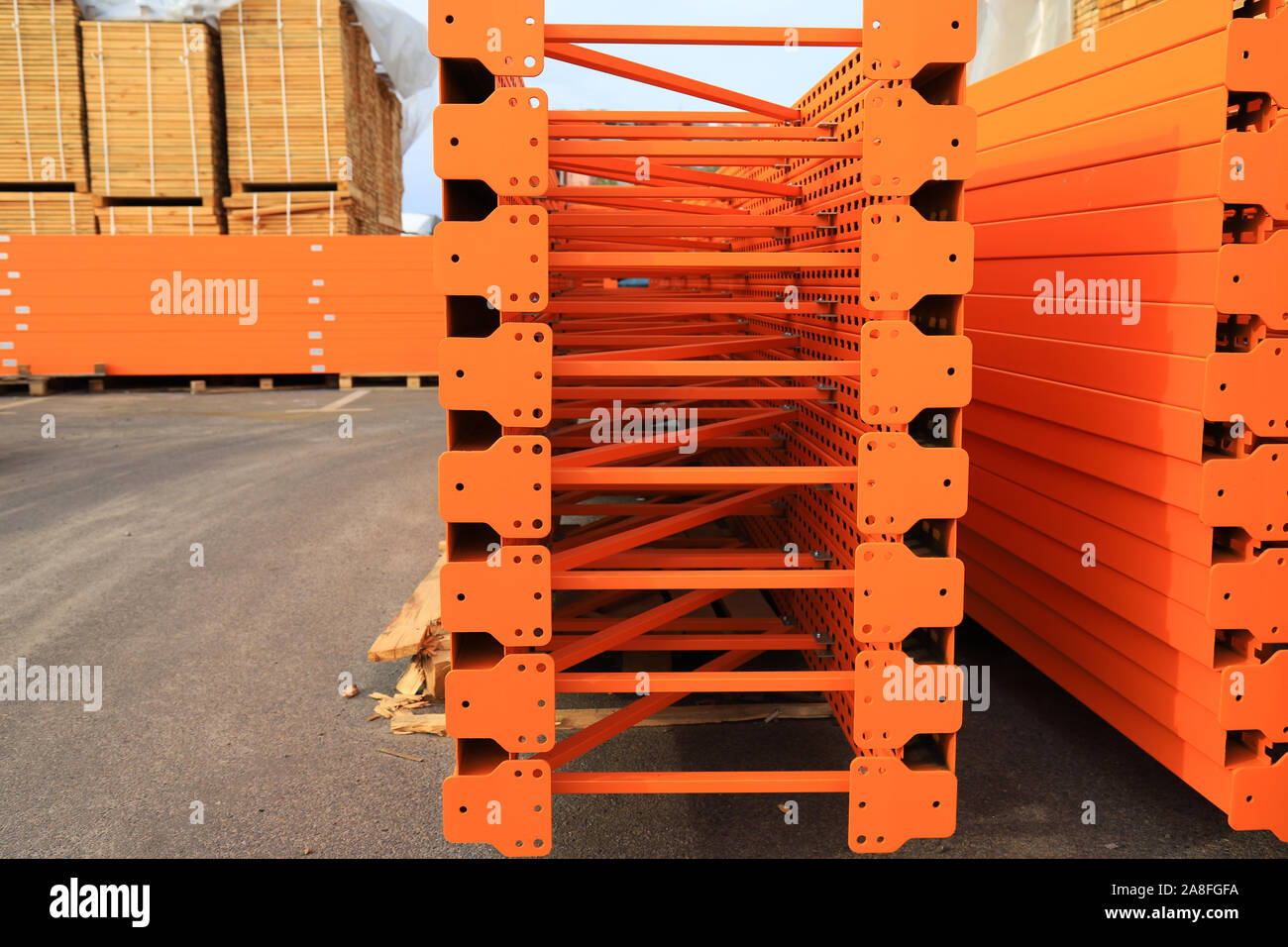 Orange big metal mobile shelving stacked in a warehouse of a construction shopping center. Placement and storage of goods in building materials stores Stock Photo