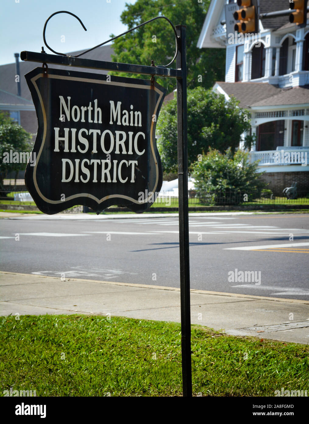 An antique style metal sign reads,  North Main Historic district, placed on the corner near Victoiran Houses in Hattiesburg, MS, USA Stock Photo