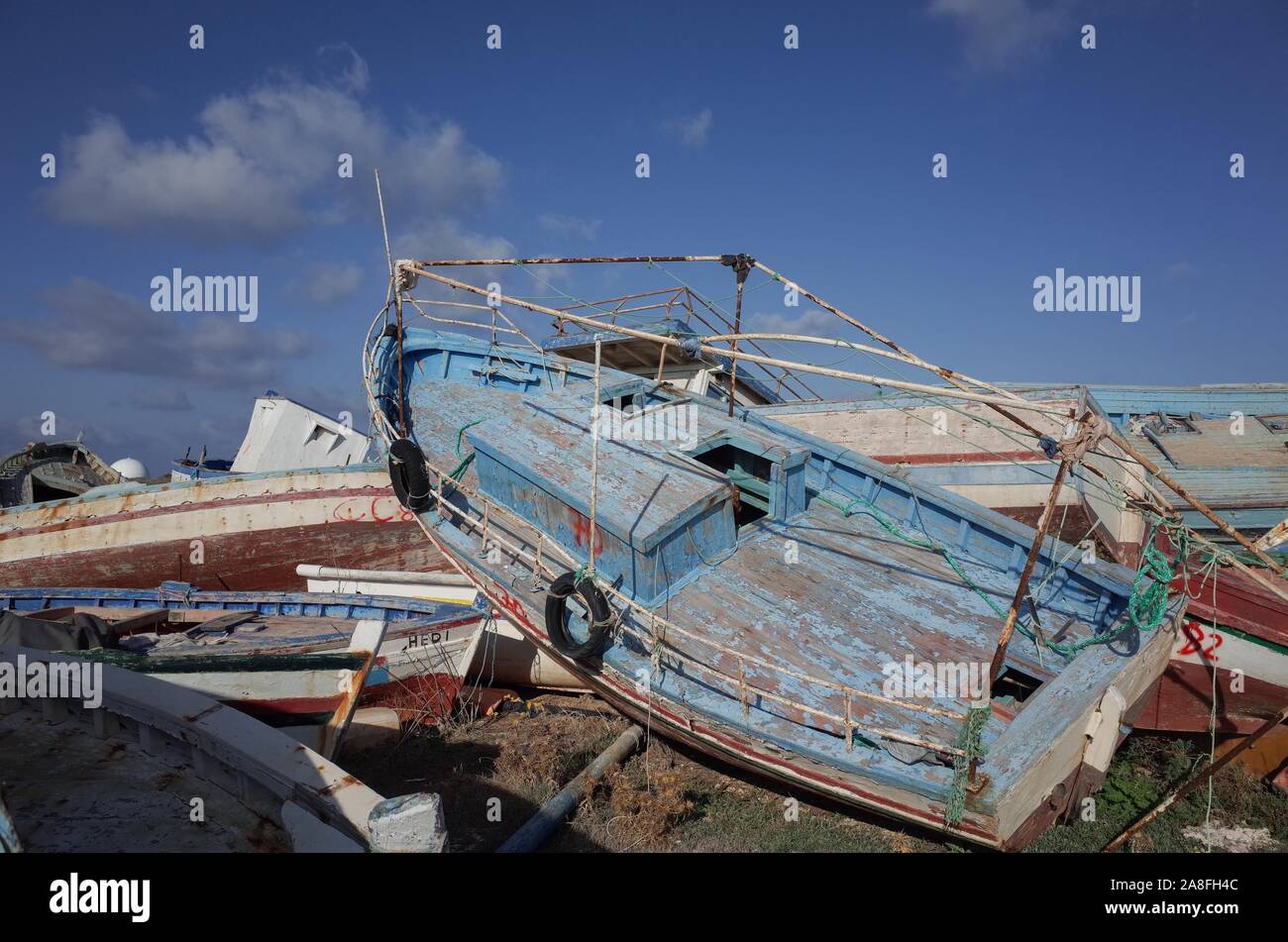 *** STRICTLY NO SALES TO FRENCH MEDIA OR PUBLISHERS *** October 21, 2019 - Lampedusa, Italia: Several boats used by migrants to cross the Mediterranean between North Africa and the Italian island of Lampedusa are abandoned in a 'boat cemetery'. Most are small Tunisian fishing vessels. Cimetiere de bateaux de migrants a Lampedusa. Stock Photo