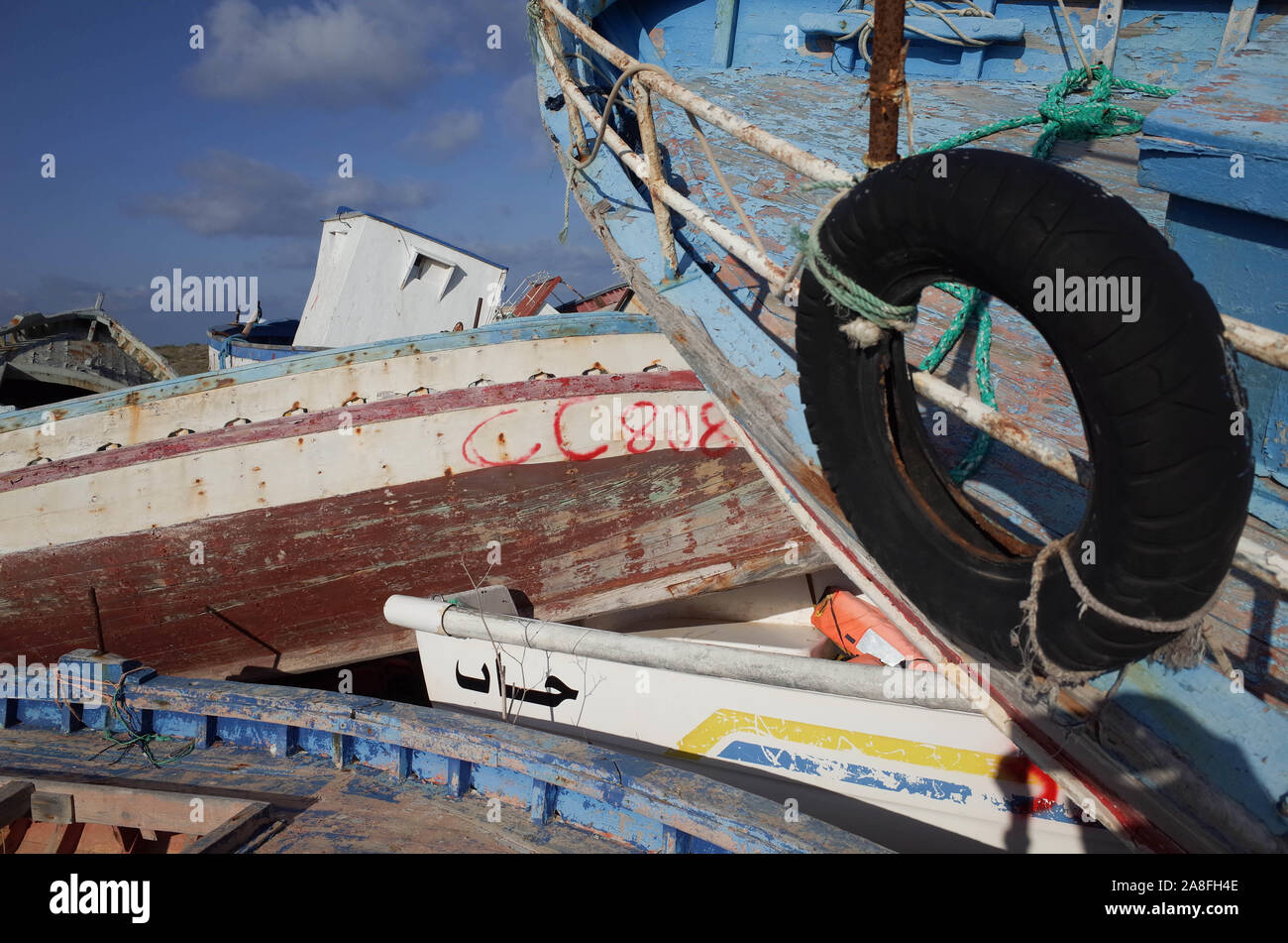 *** STRICTLY NO SALES TO FRENCH MEDIA OR PUBLISHERS *** October 21, 2019 - Lampedusa, Italia: Several boats used by migrants to cross the Mediterranean between North Africa and the Italian island of Lampedusa are abandoned in a 'boat cemetery'. Most are small Tunisian fishing vessels. Cimetiere de bateaux de migrants a Lampedusa. Stock Photo