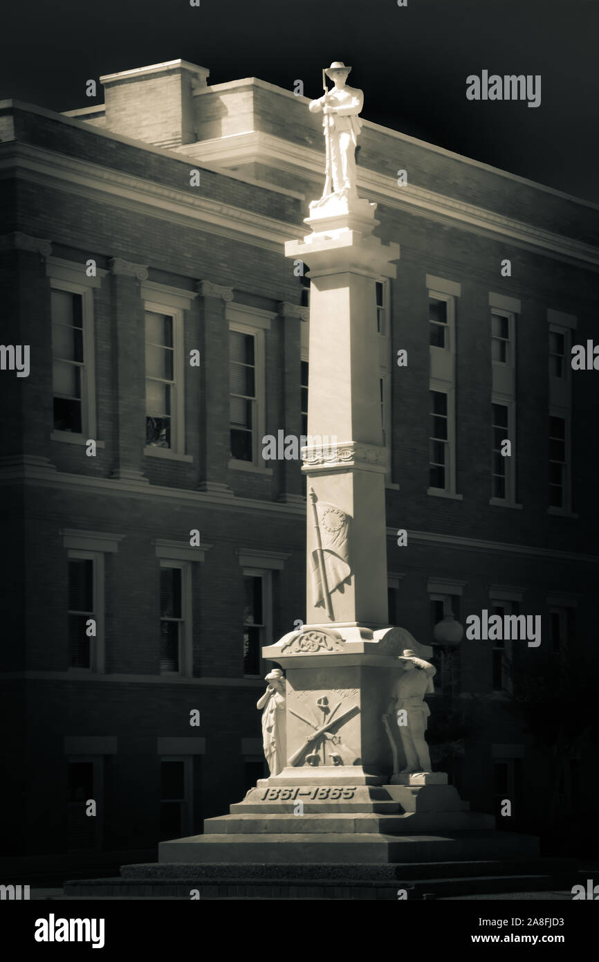 An infrared effect of an approximately three story tall marble monument with a sculpture of a Confederate Solider atop,  beside the Forrest County Cou Stock Photo