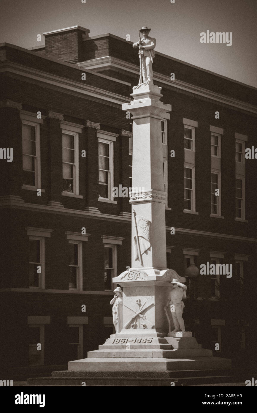 An Approximately three story tall marble monument with a sculpture of a Confederate Solider atop,  beside the Forrest County Courthouse in Hattiesburg Stock Photo