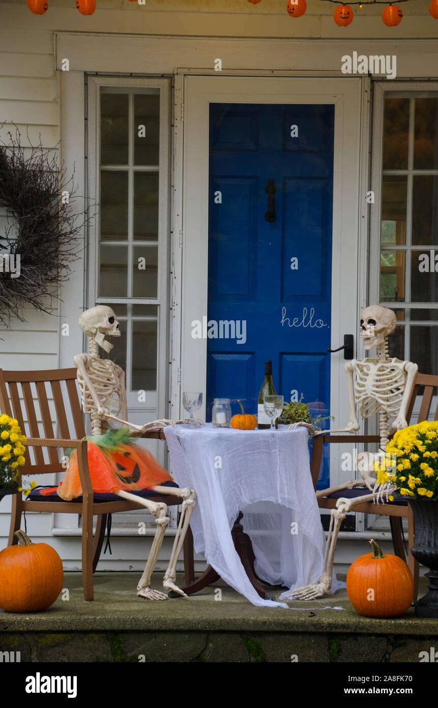 Two Skeletons couple sitting a dining table having wine for Halloween romantic date night, Yarmouth, Maine, USA Stock Photo