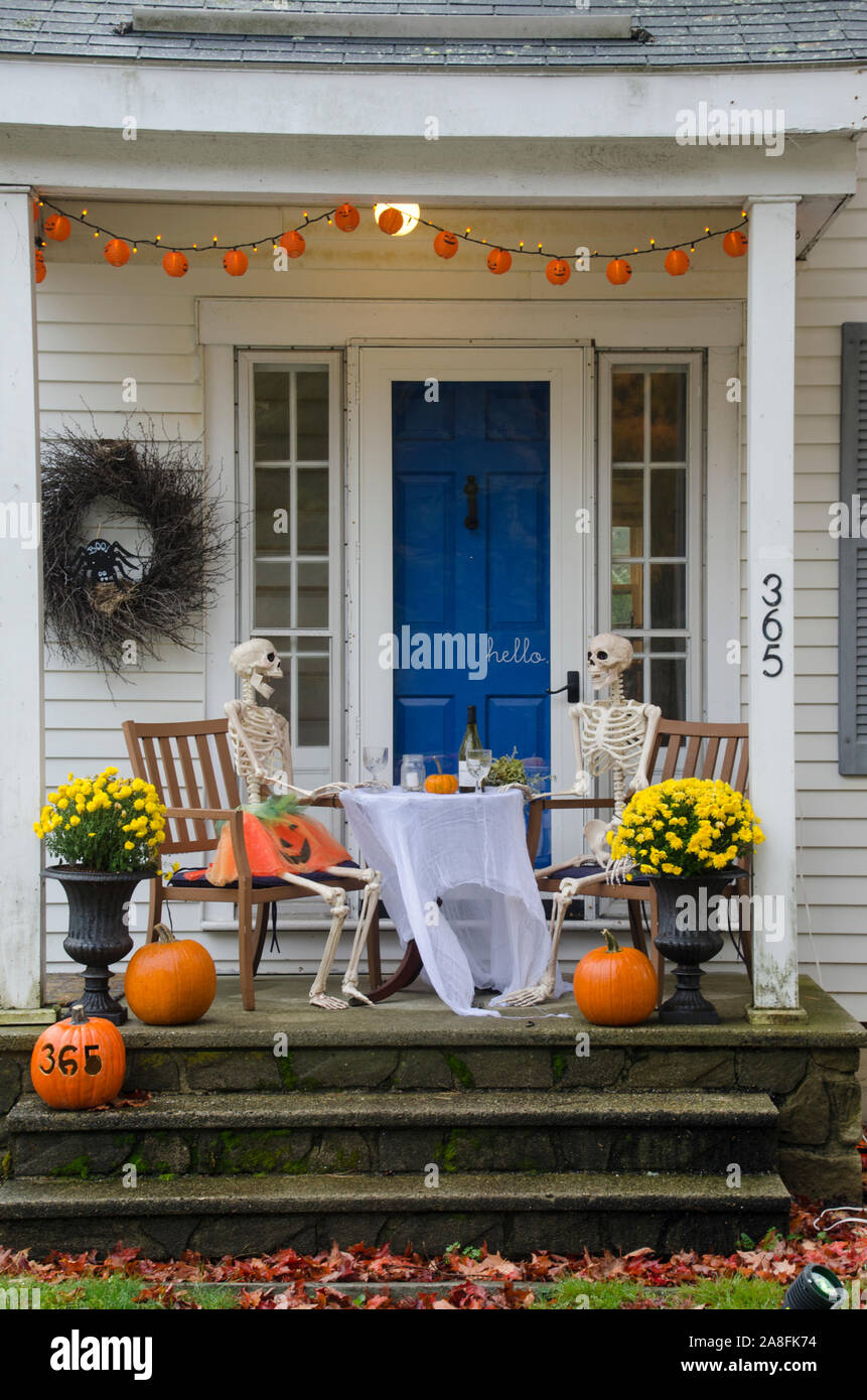 Two skeletons sitting together for a romantic date night with wine for Halloween, Yarmouth, Maine, USA Stock Photo