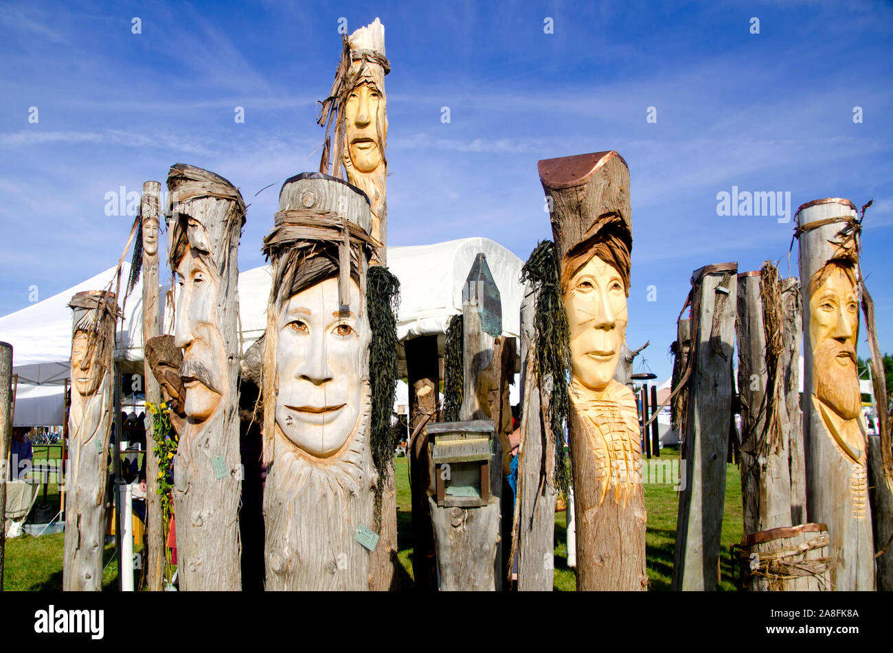 Faces carved in trees at Common ground fair, Unity Maine Stock Photo