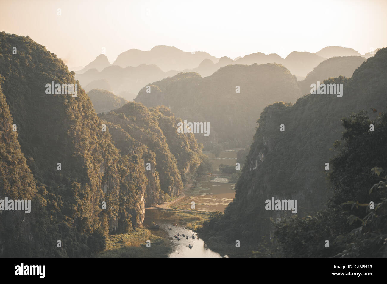 Beautiful sunset over Vietnamese rivers and Landscape from the scenic Mua Caves and Dragon Statue in Tam Coc, Ninh Binh, Vietnam Stock Photo