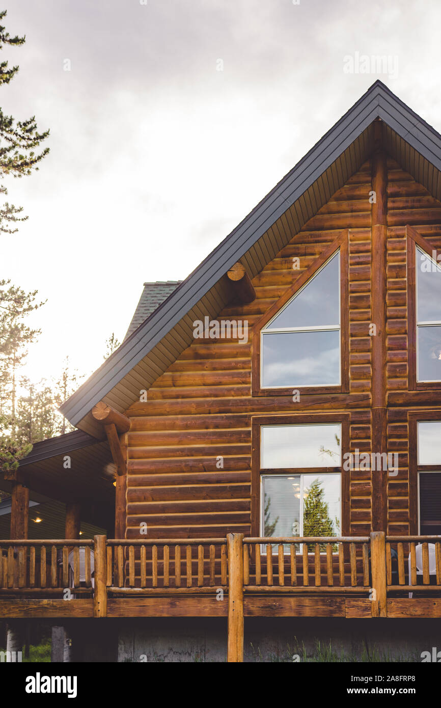 Image showcasing Wooden beam log cabin amidst lush forest Stock Photo - Alamy