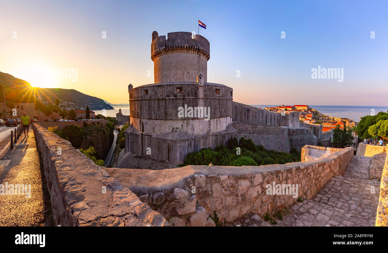 Old city walls with sight on Minceta Tower and Old Harbour of Dubrovnik at sunrise in Dubrovnik, Croatia Stock Photo