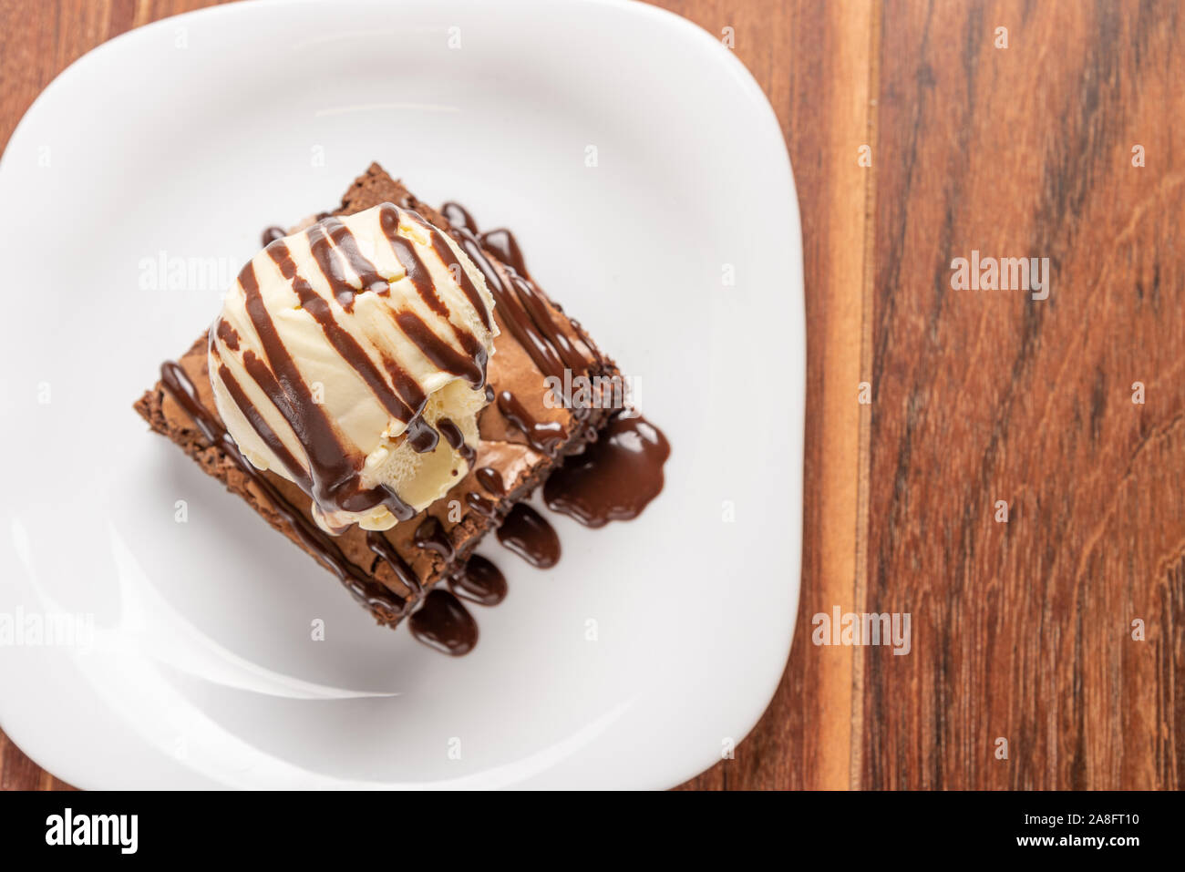 Chocolate Brownie with Vanilla Ice Cream and chocolatel syrup isolated ...
