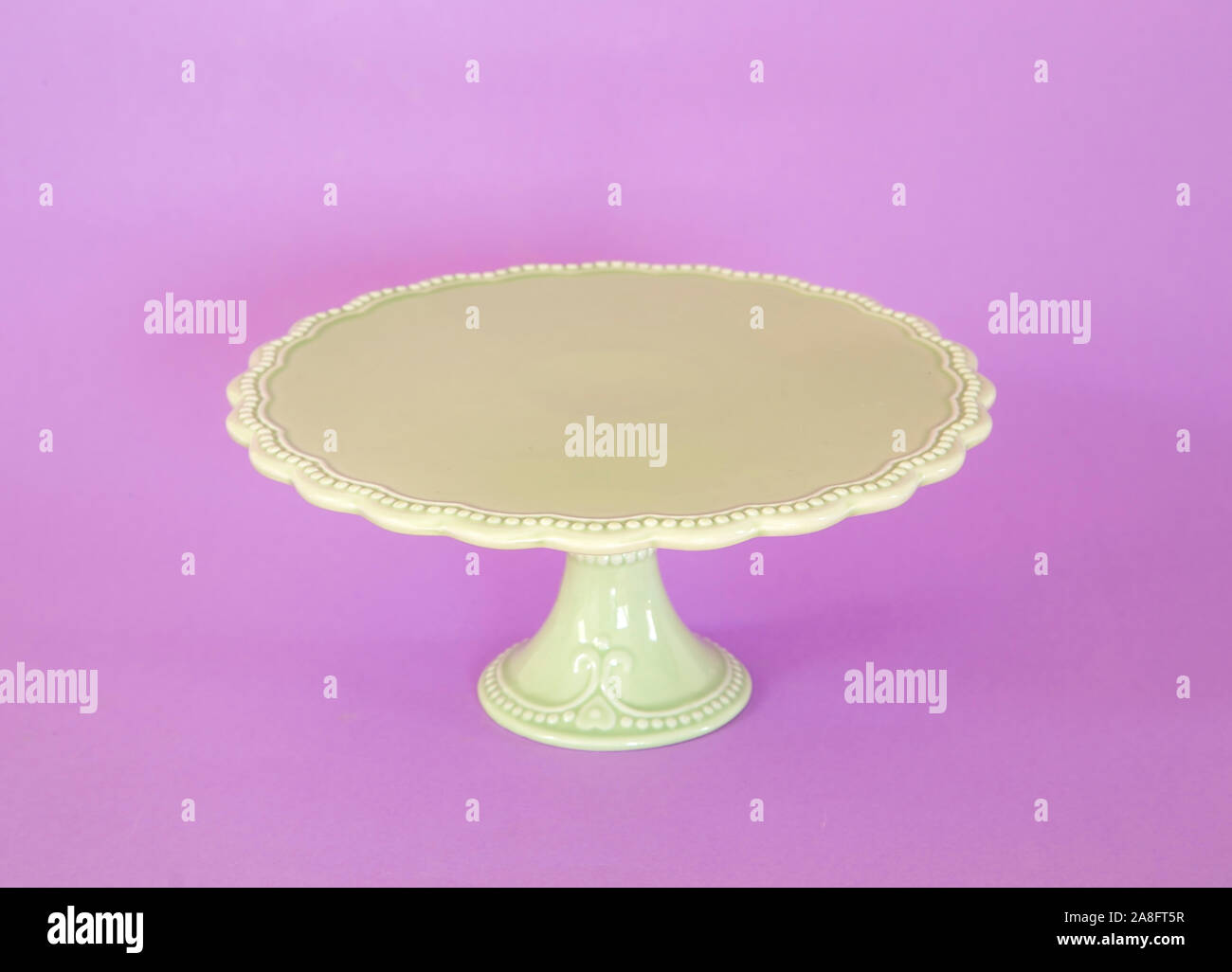Green vintage cakestand on purple background Stock Photo