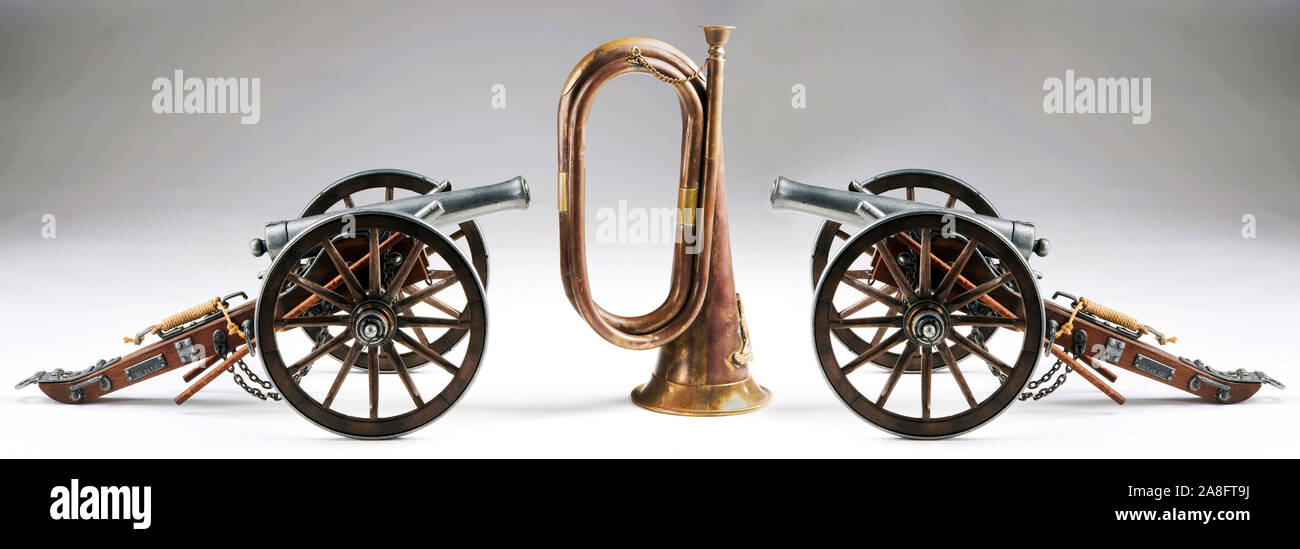 Old cannons and old brass bugle. Stock Photo