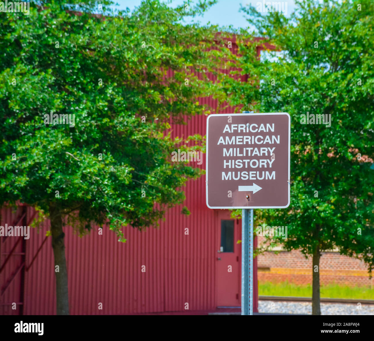 A metal sign for the African American Military History Museum in small
