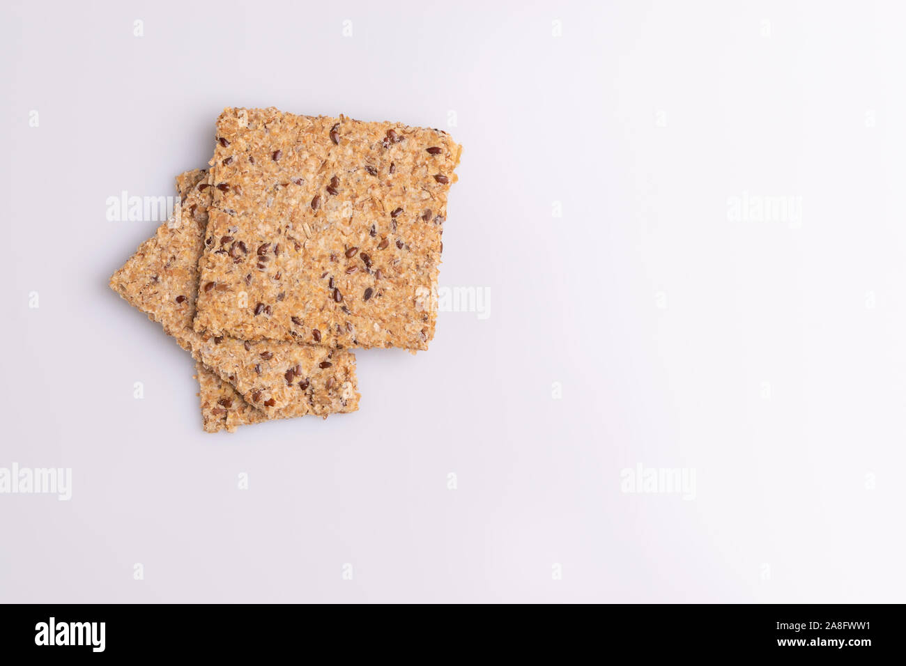 Diet flax seed whole grain crackers isolated on white background, soft light, copy space Stock