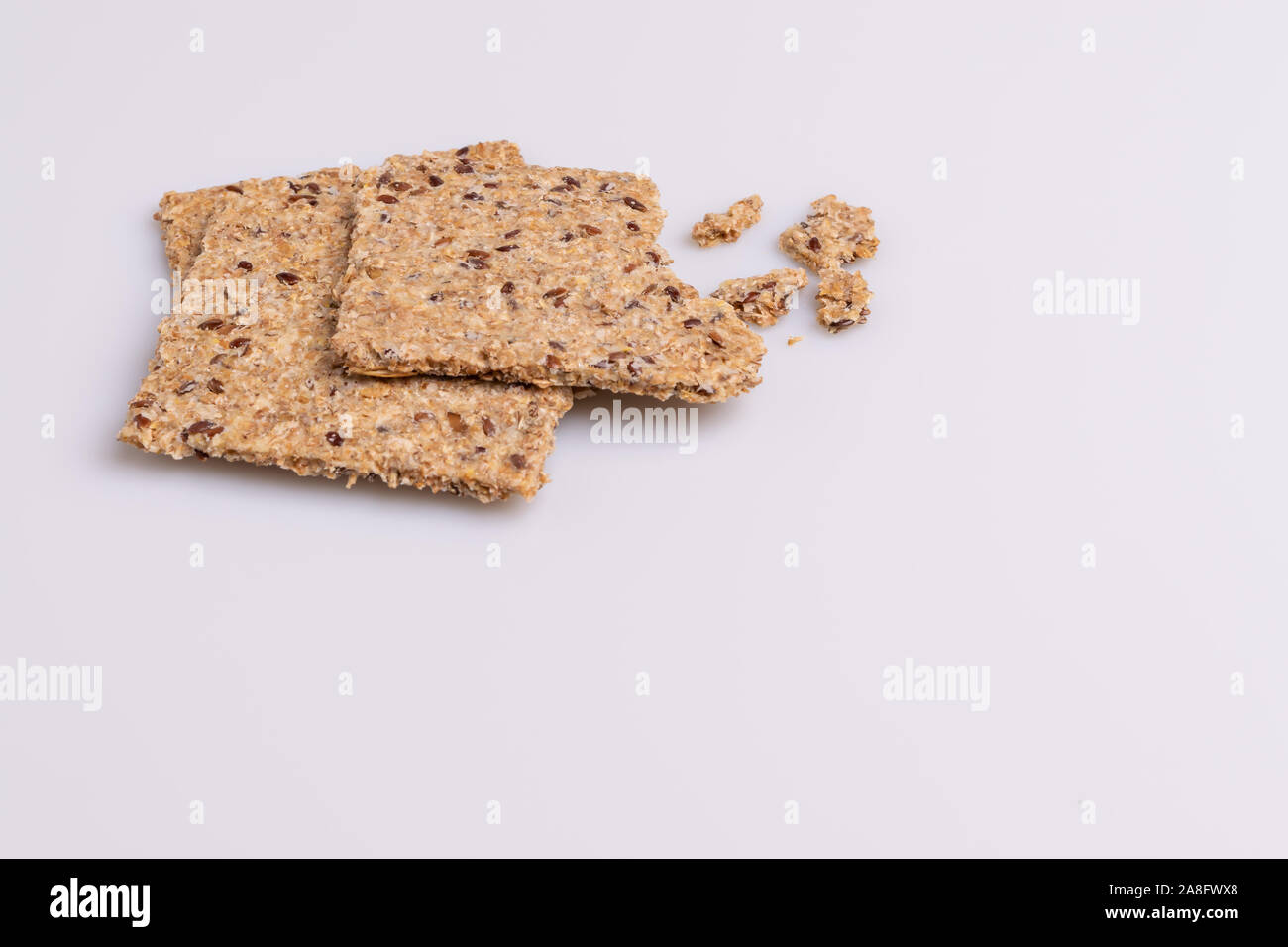 Diet flax seed whole grain crackers isolated on white background, soft light, copy space Stock