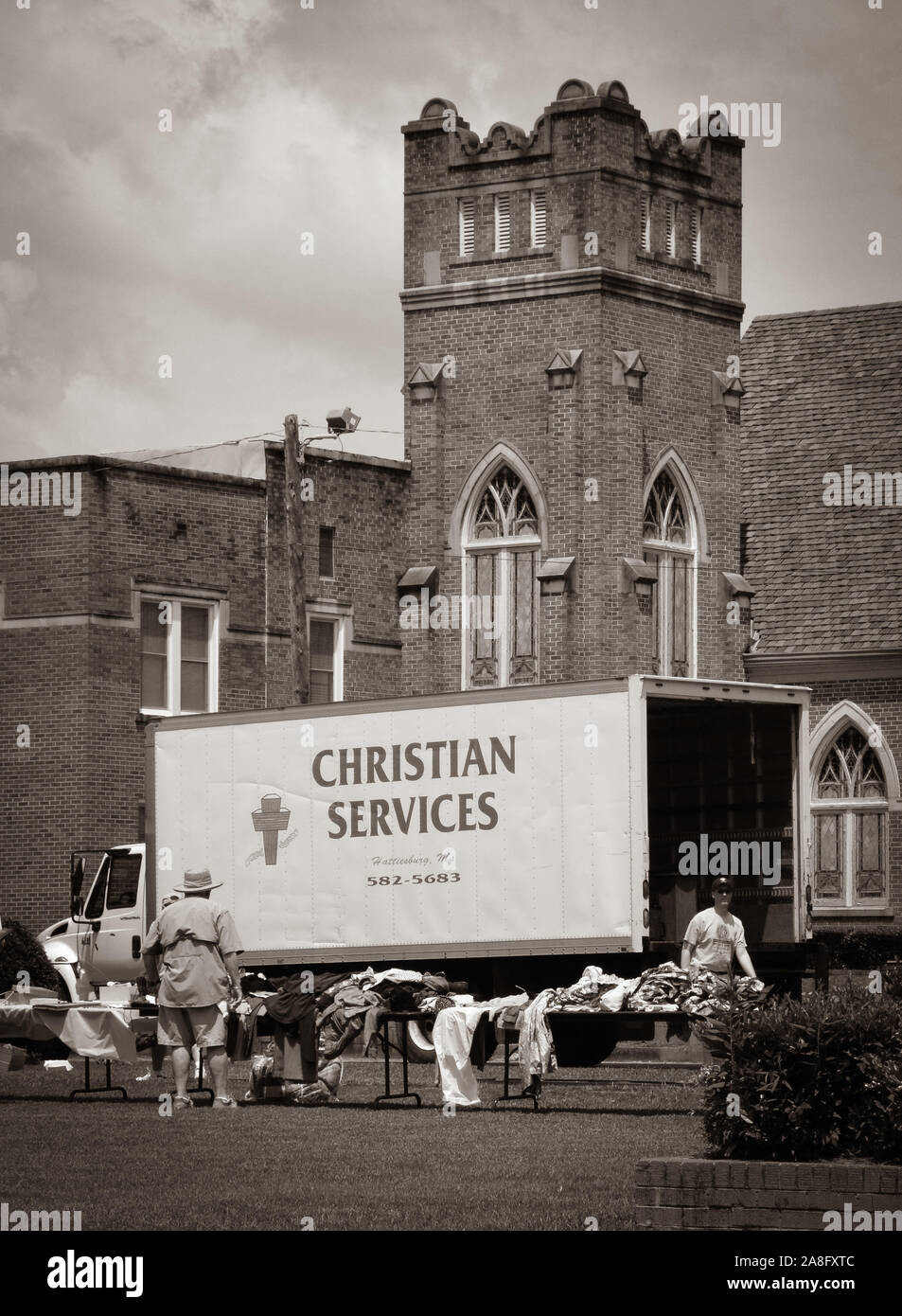 Gounds of the Central Christian Church and the True Light Missionary Baptist Church with people receiving and giving charitable Christian Services, MS Stock Photo