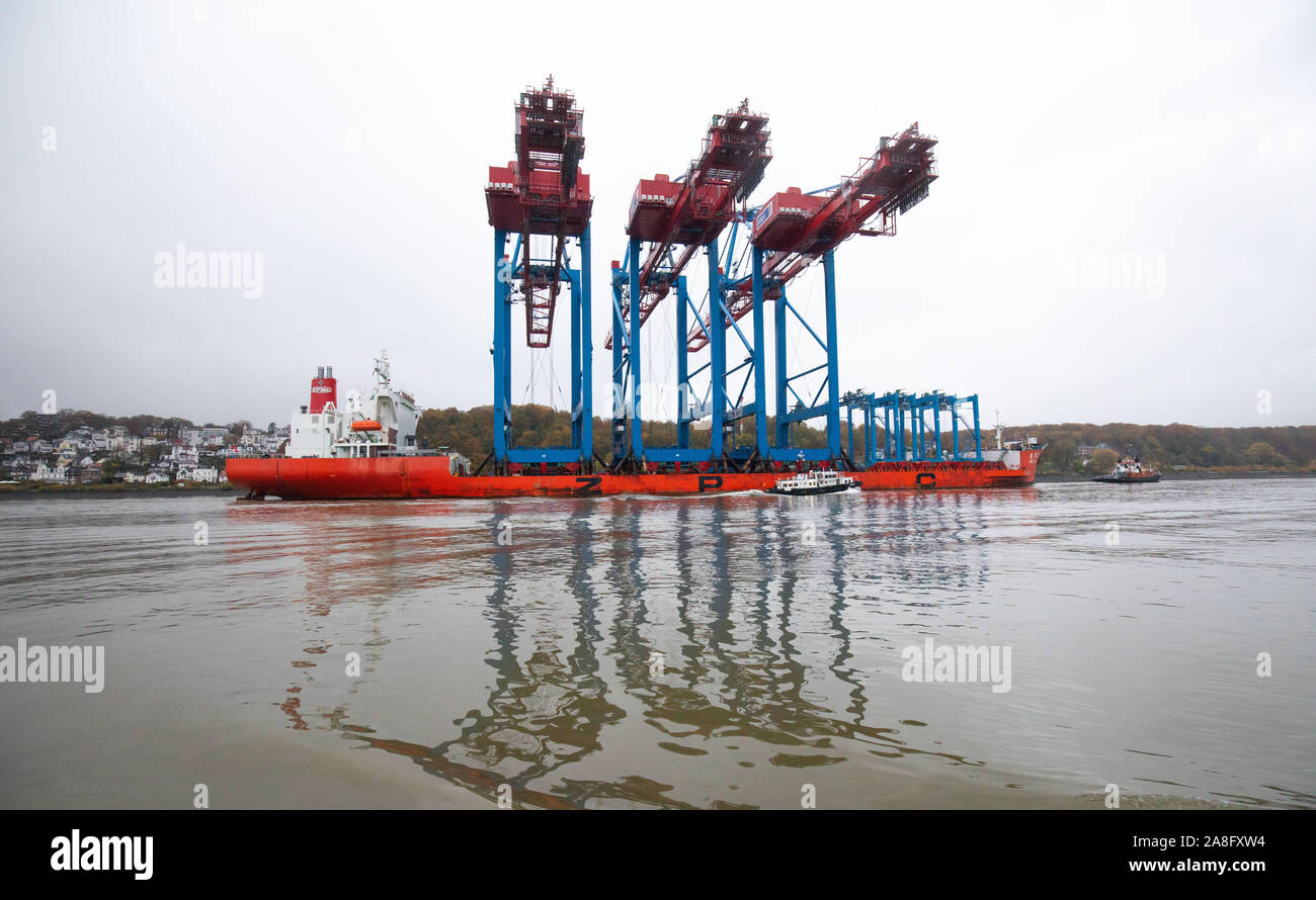 Hamburg, Germany. 05th Nov, 2019. The special ship Zhen Hua 27 with three new container gantry cranes for Hamburger Hafen und Logistik AG (HHLA) is heading for Hamburg on the Elbe before Blankenese. With the new container gantry cranes for Container Terminal Burchardkai (CTA), HHLA is creating additional capacities for handling particularly large container ships with a cargo volume of 23,000 standard containers (TEU) and more. Credit: Christian Charisius/dpa/Alamy Live News Stock Photo