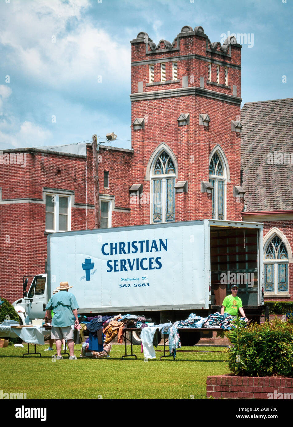 Gounds of the Central Christian Church and the True Light Missionary Baptist Church with people receiving and giving charitable Christian Services, MS Stock Photo