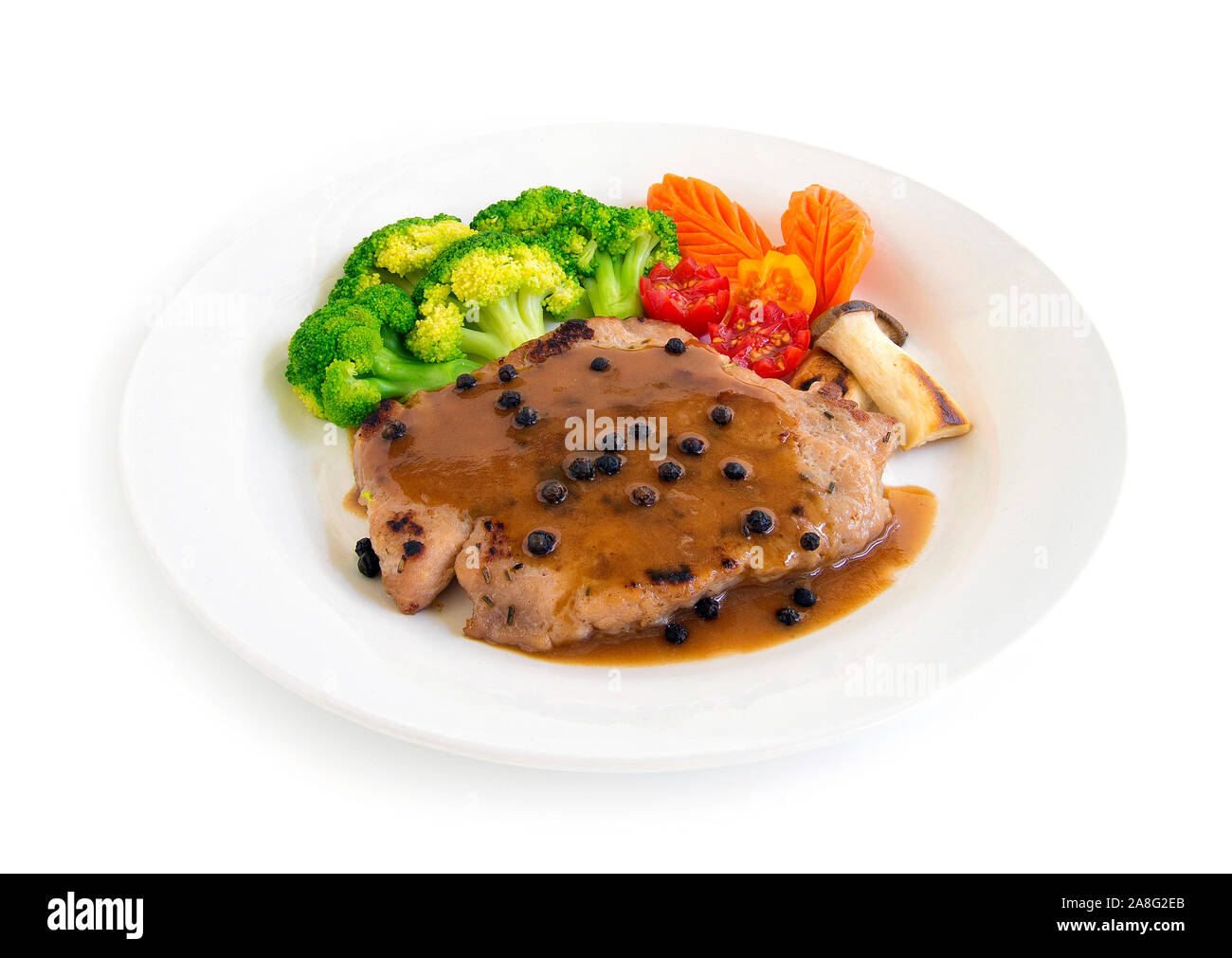 Pork steak with gravy sauce topped black peppers decorate broccoli