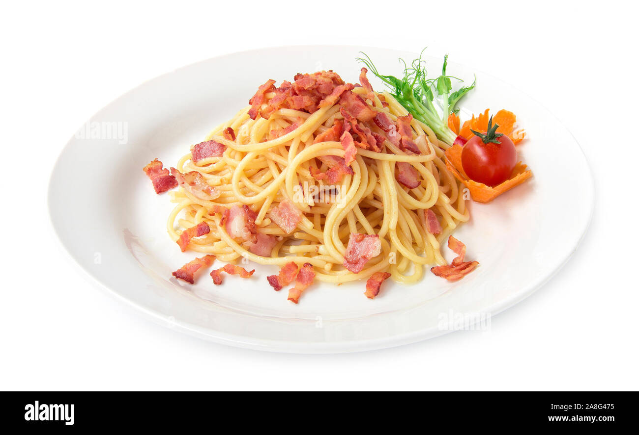 Spaghetti stir fried with bacon on top bacon crispy simply goodtasty fusion food  Italian traditional style decorate with pea sprouts, carved carrots Stock Photo