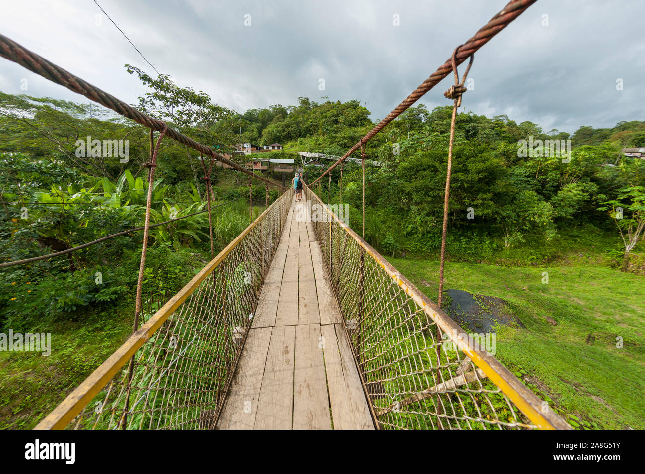 Foot bridge leading across the Rio Danubio near the village of San Cipriano in the department of Valle del Cauca, Colombia. Stock Photo