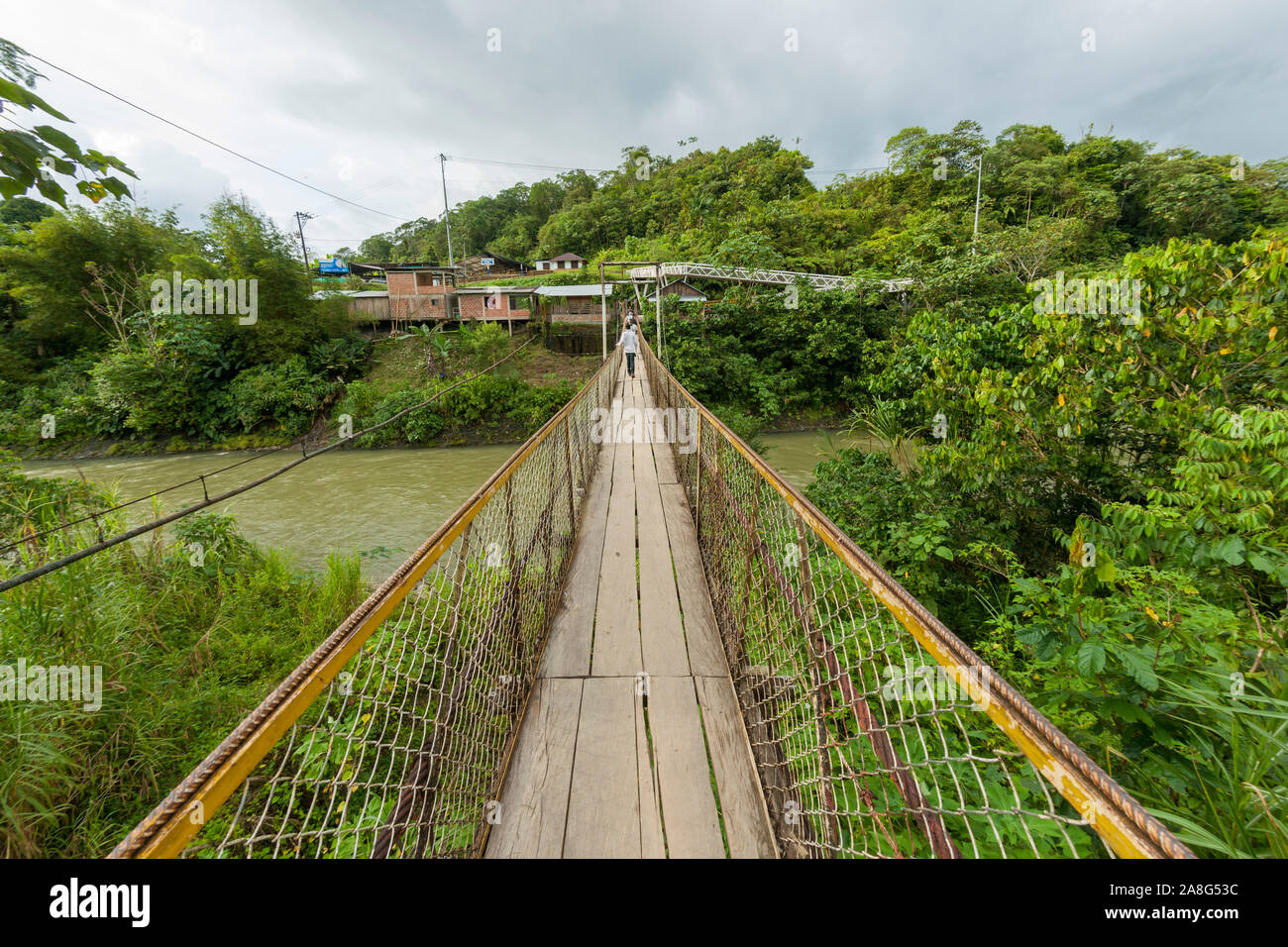 Foot bridge leading across the Rio Danubio near the village of San Cipriano in the department of Valle del Cauca, Colombia. Stock Photo