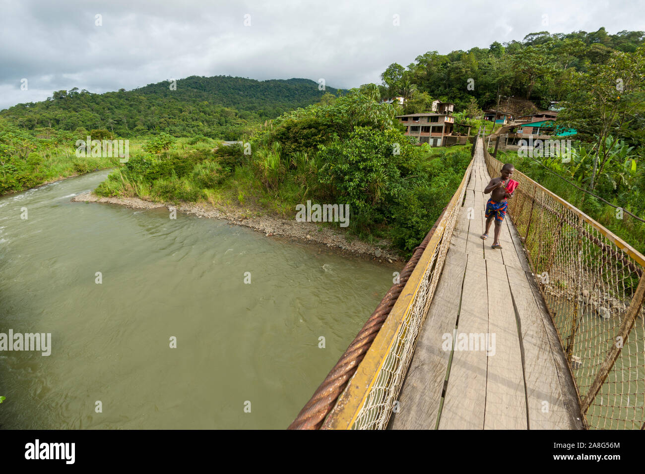 Foot bridge leading across the Rio Danubio near the village of San Cipriano in the department of Valle del Cauca, Colombia. Stock Photo