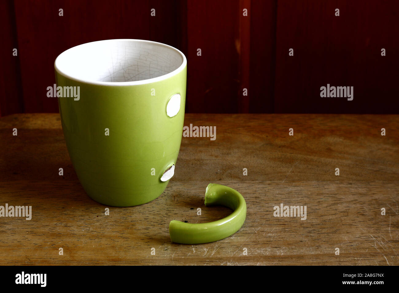 Photo of a green ceramic mug with broken handle Stock Photo Alamy