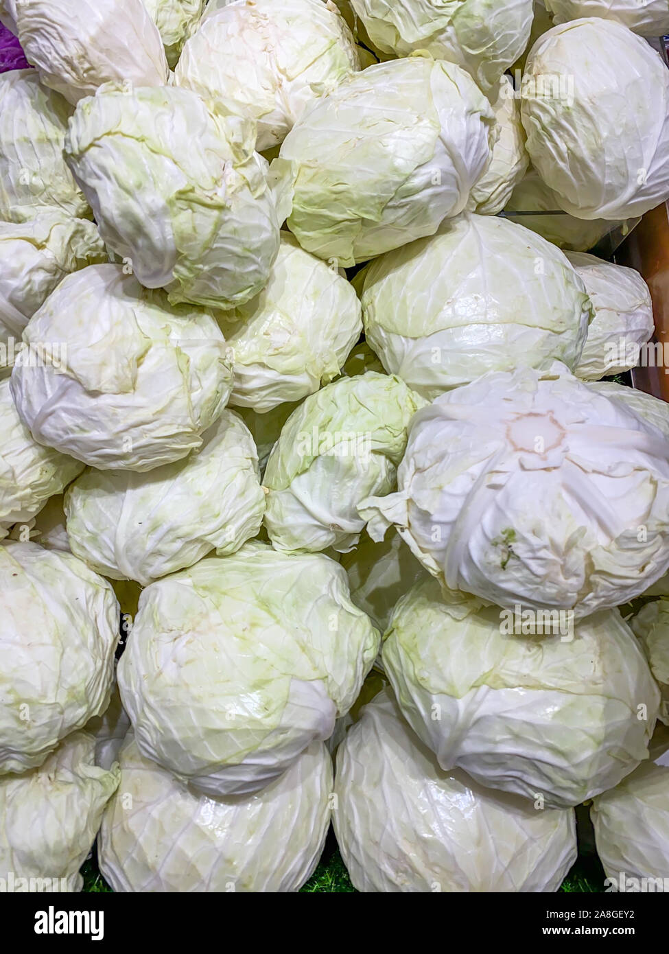 Pile of green cabbage for sale at grocery market Stock Photo Alamy