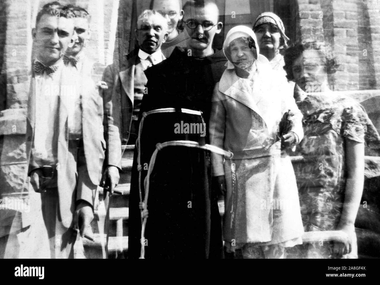 Photographic double exposure of a family portrait with seminarian son, ca. 1930. Stock Photo