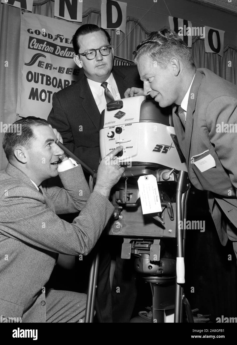 Geeky white men check the wares at a sporting goods convention in a promotional photo in Southern California, ca. 1955. Stock Photo