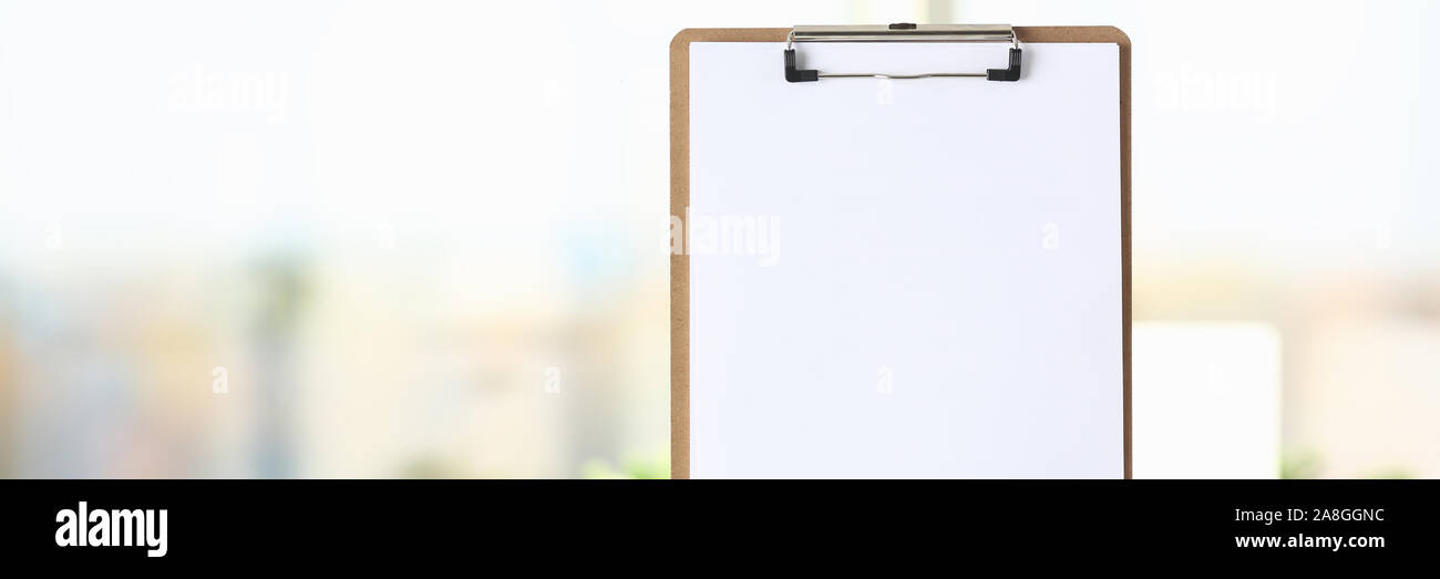 Businessman holds clipboard with paper Stock Photo