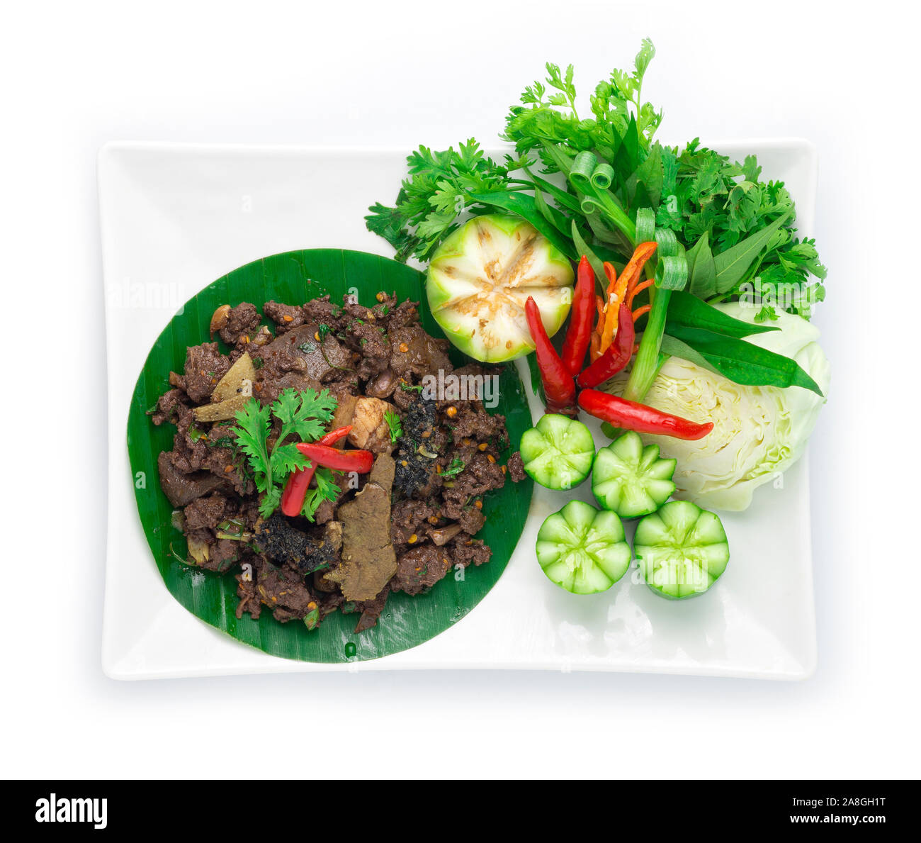Spicy Minced Beef Salad cooked with ingredient Spicy Herbs Thai Food Popular in Northern Style decorate with carved cucumber and vegetables top view Stock Photo