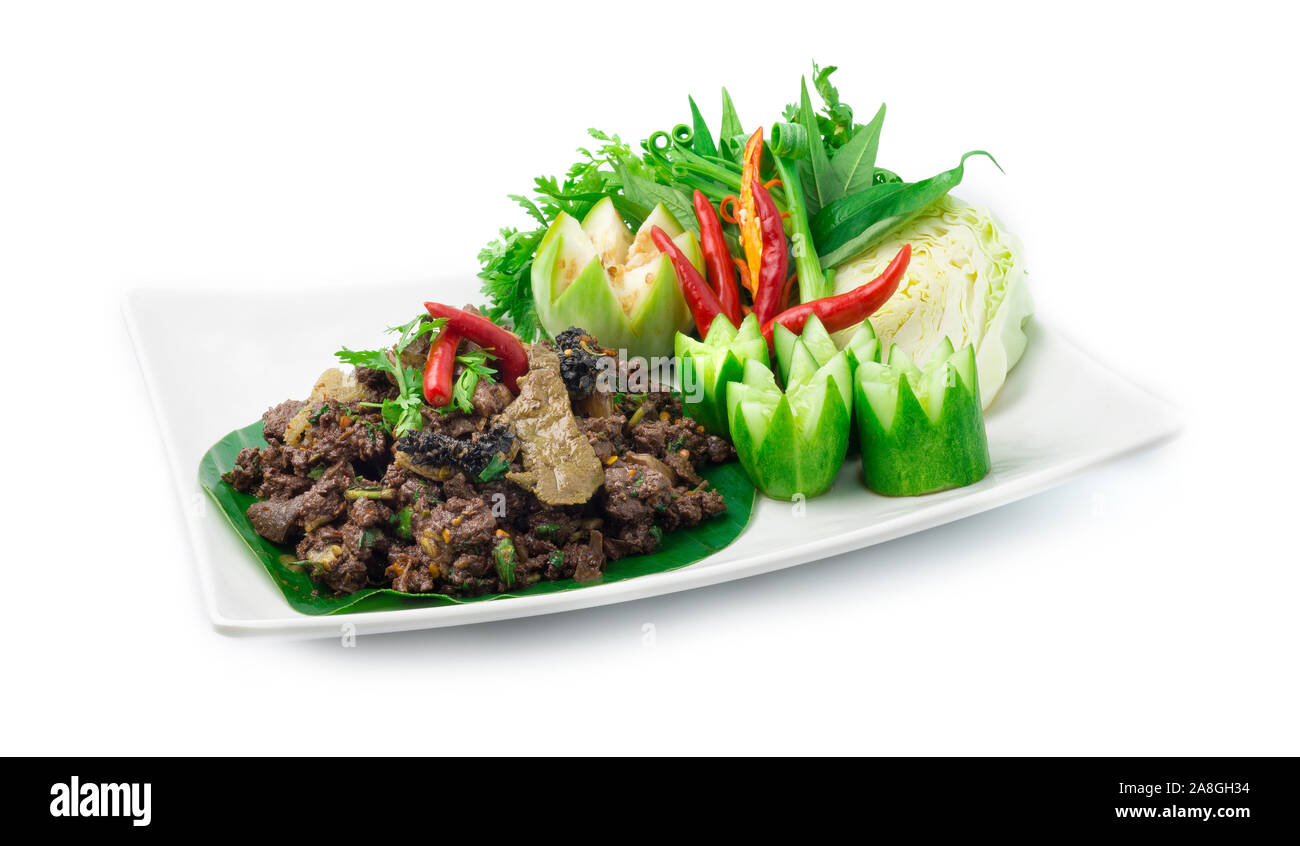 Spicy Minced Beef Salad cooked with ingredient Spicy Herbs Thai Food Popular in Northern Style decorate with carved cucumber and vegetables. side view Stock Photo