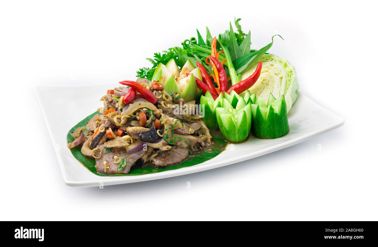 Spicy Offal Beef Salad Cooked with ingredient Spicy Herbs Thai Food Popular in Northern Style decorate with carved cucumber and vegetable side view Stock Photo