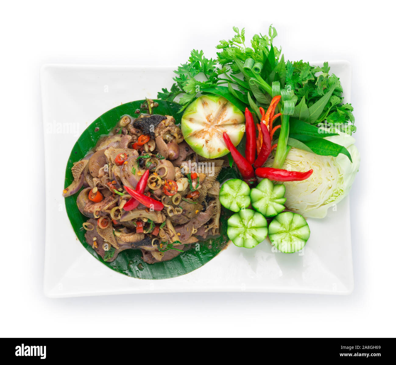 Spicy Offal Beef Salad Cooked with ingredient Spicy Herbs Thai Food Popular in Northern Style decorate with carved cucumber and vegetable top view Stock Photo