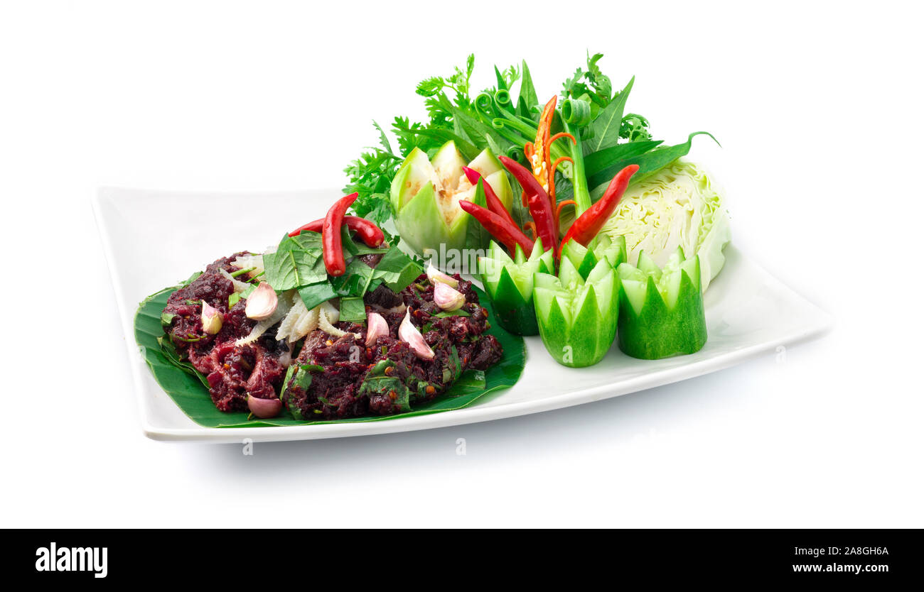 Spicy Raw Minced Beef Salad ingredient Spicy Herbs Thai Food Popular in Northern Style decorate with carved cucumber and vegetables side view Stock Photo