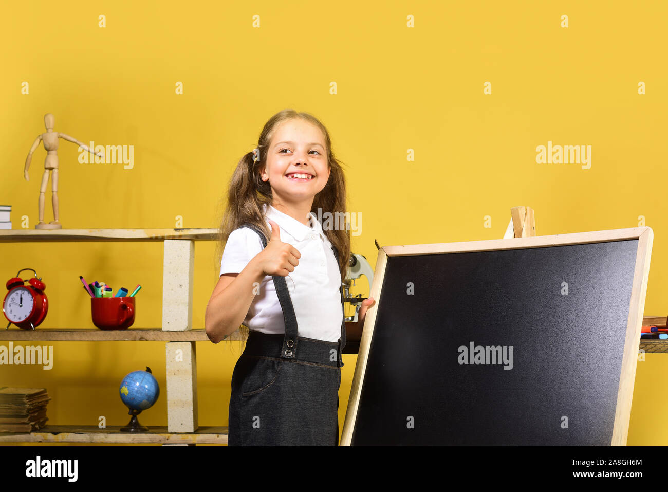 Kid And School Supplies On Yellow Background Schoolgirl With